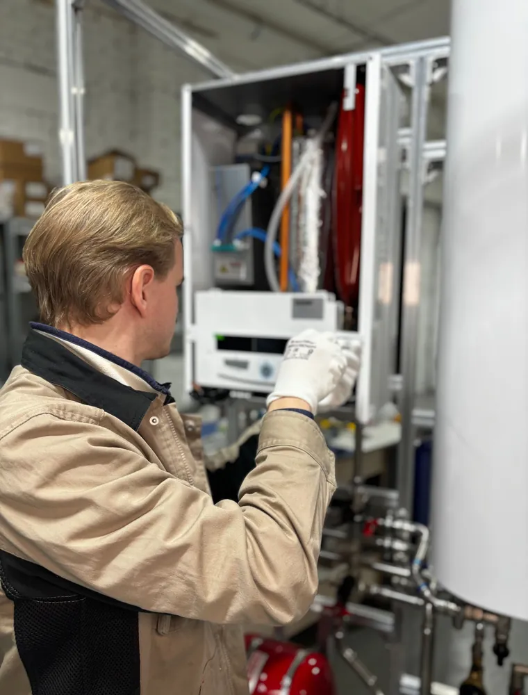 Engineer fitting a component at a boiler