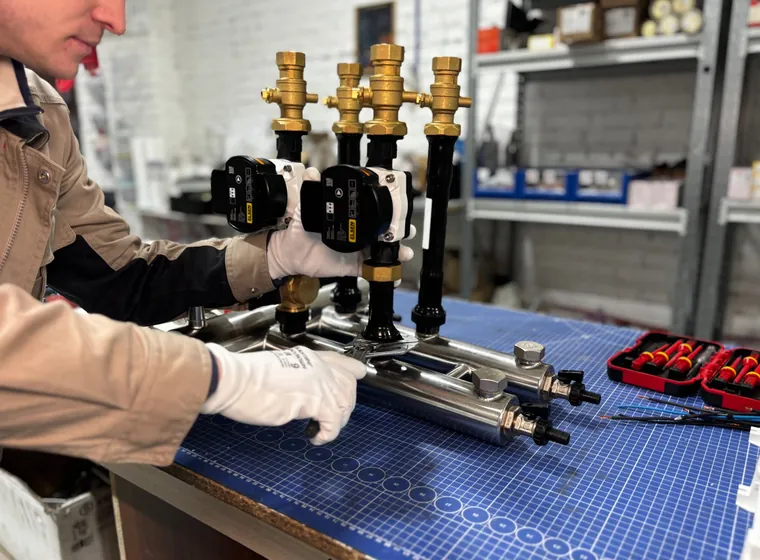 Engineer assembling a pump group on a bench