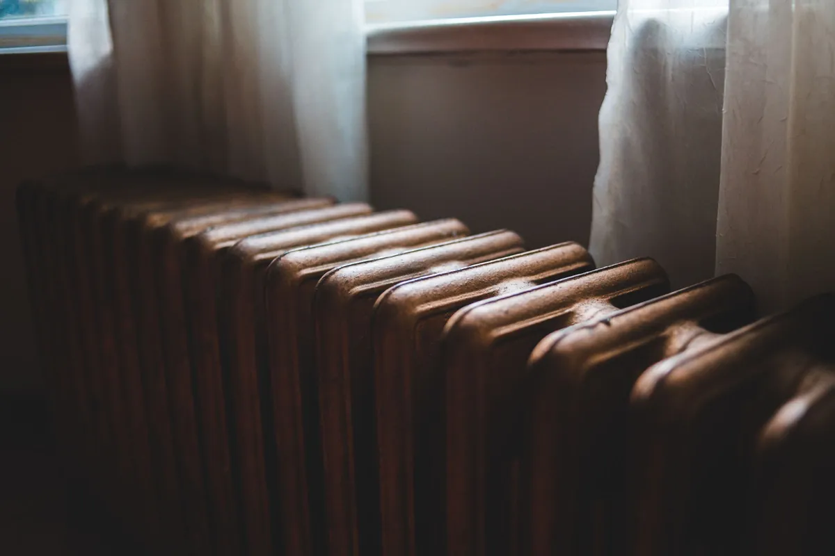 Old cast iron radiator in a sunlit room