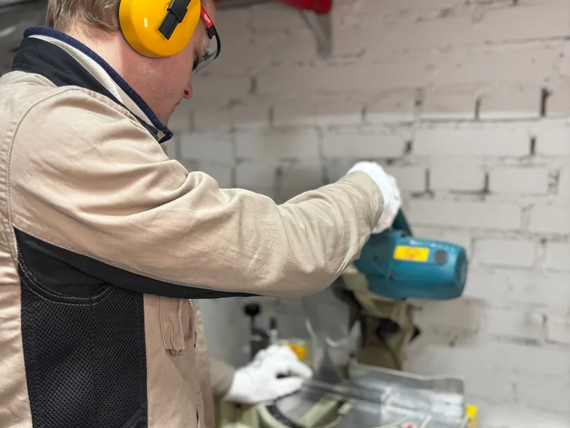 Engineer drilling a wall for a fixing