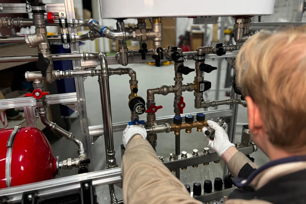 Engineer checking pressure on a heating manifold